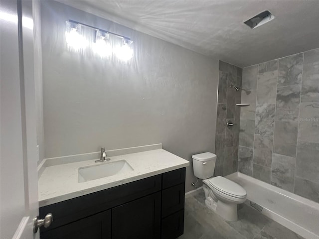 bathroom featuring a tile shower, toilet, and vanity