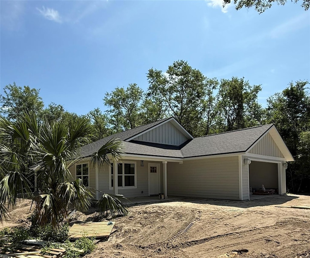 6333 Fox Hollow Ct, Hampton, FL 32044 - view of front facade featuring a garage and board and batten siding