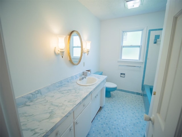 full bathroom with toilet and vanity