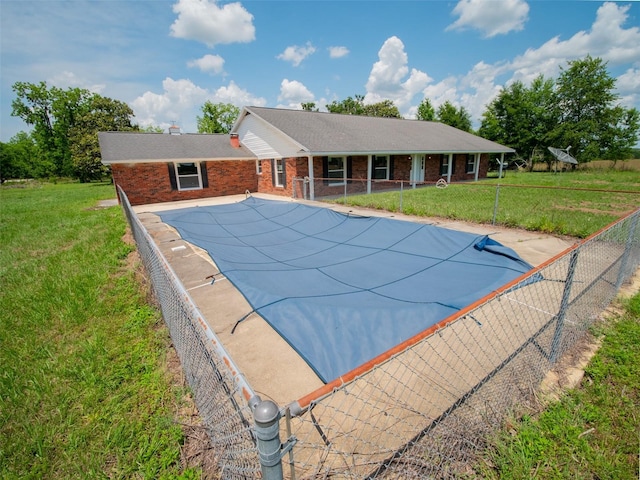 view of swimming pool with a lawn, fence, and a fenced in pool