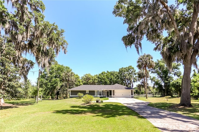 ranch-style house with a garage, driveway, and a front yard