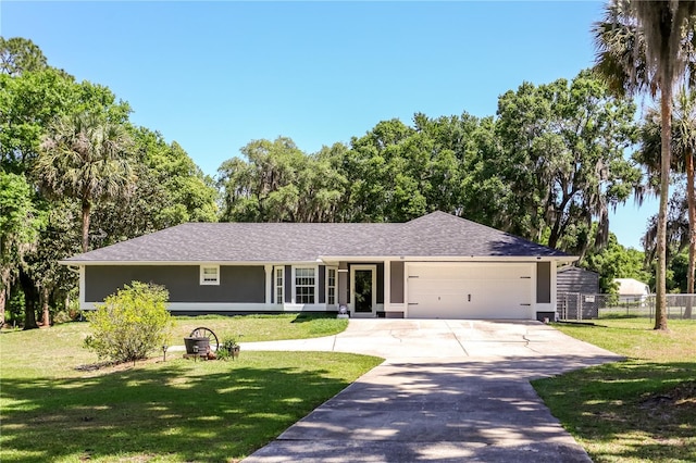 single story home with a front lawn, concrete driveway, fence, an attached garage, and stucco siding