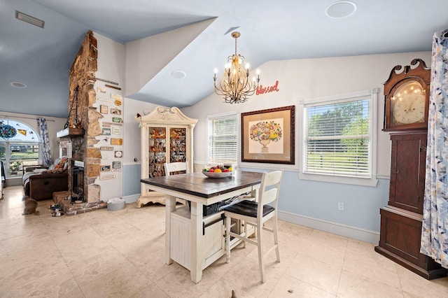 dining area featuring a chandelier, visible vents, lofted ceiling, and plenty of natural light