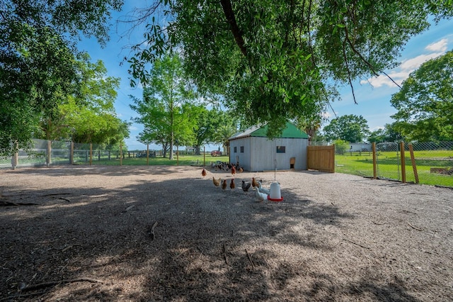 view of yard with an outdoor structure and fence