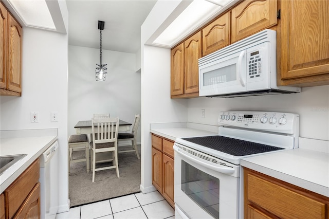 3653 NW 67th Ave, Gainesville, FL 32653 - kitchen featuring hanging light fixtures, white appliances, light tile patterned floors, light carpet, and light countertops