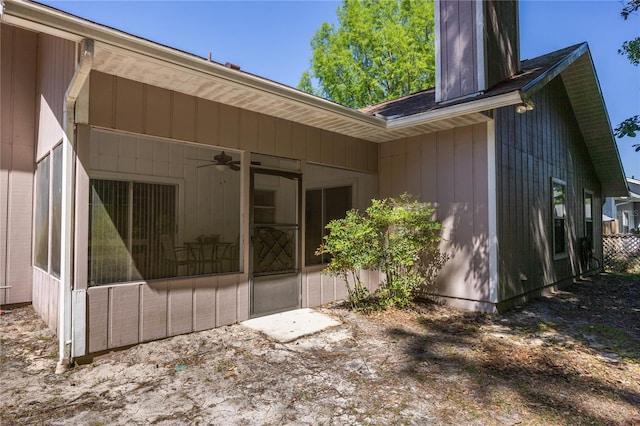 3653 NW 67th Ave, Gainesville, FL 32653 - back of property with a ceiling fan, a sunroom, and a chimney