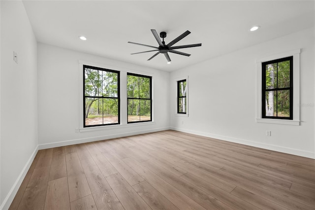 spare room with baseboards, a ceiling fan, wood finished floors, and recessed lighting