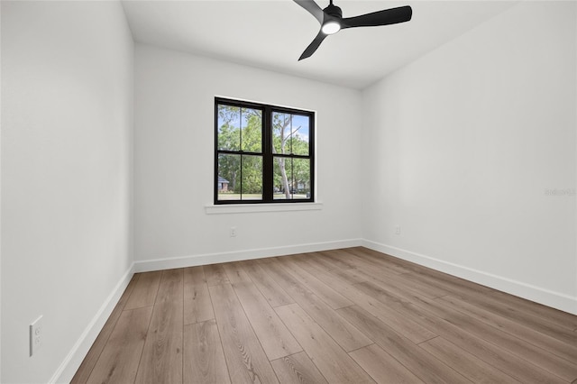 empty room with baseboards, ceiling fan, and wood finished floors