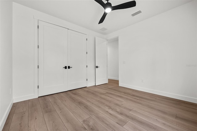 unfurnished bedroom with baseboards, visible vents, and wood finished floors