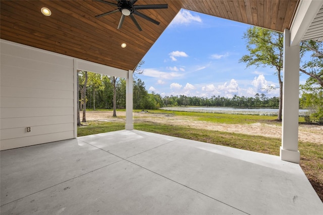 view of patio featuring a water view and a ceiling fan