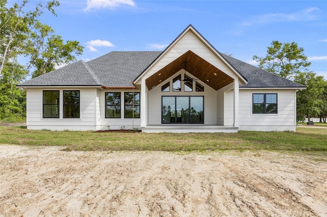 back of property with a shingled roof