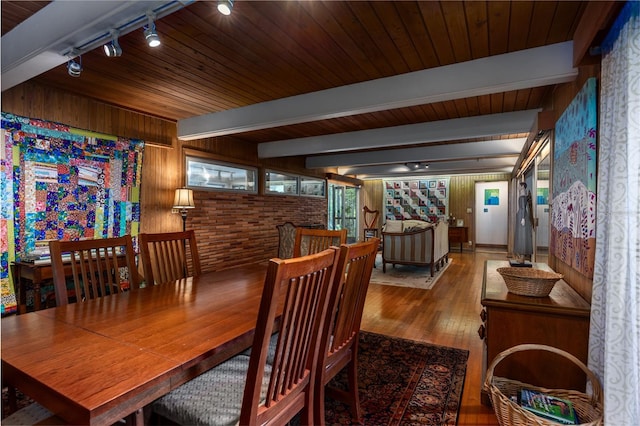 2074 NW 11th Rd, Gainesville, FL 32605 - dining room featuring track lighting, wood finished floors, wooden walls, and wooden ceiling with exposed beams