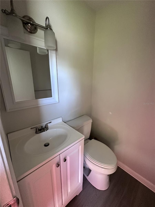 4606 NW 41st Pl Unit 107, Gainesville, FL 32606 - bathroom with vanity, baseboards, wood finished floors, and toilet