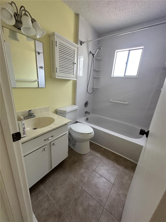 4606 NW 41st Pl Unit 107, Gainesville, FL 32606 - bathroom with a textured ceiling, bathtub / shower combination, vanity, tile patterned floors, and toilet