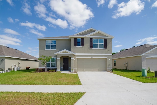 view of front of house with an attached garage, stucco siding, driveway, and a front yard