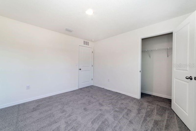 6683 SE 3rd Loop, Ocala, FL 34472 - unfurnished bedroom with carpet, visible vents, baseboards, and a closet