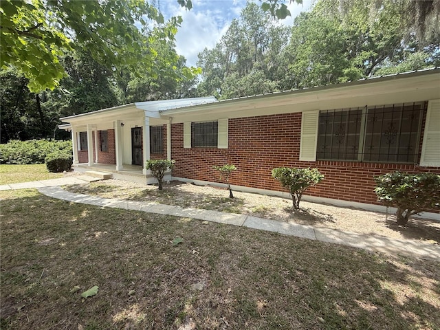 3436 SW 20th St, Gainesville, FL 32608 - ranch-style house featuring a porch and brick siding