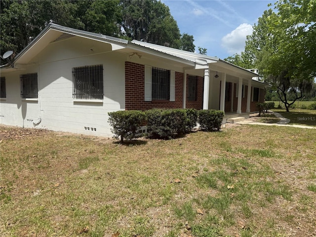 3436 SW 20th St, Gainesville, FL 32608 - view of home's exterior with a lawn and brick siding