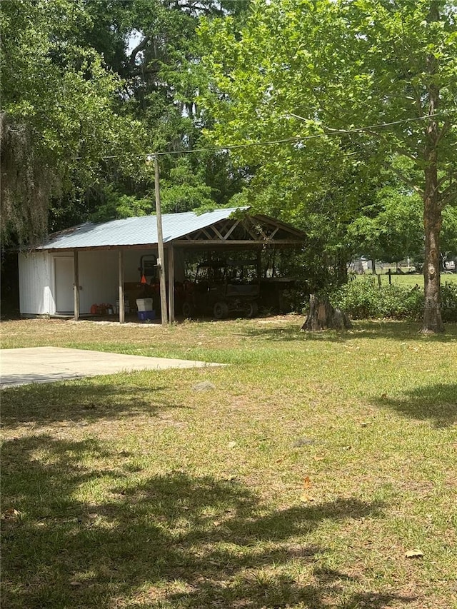 3436 SW 20th St, Gainesville, FL 32608 - exterior space featuring a detached carport, a yard, and an outdoor structure