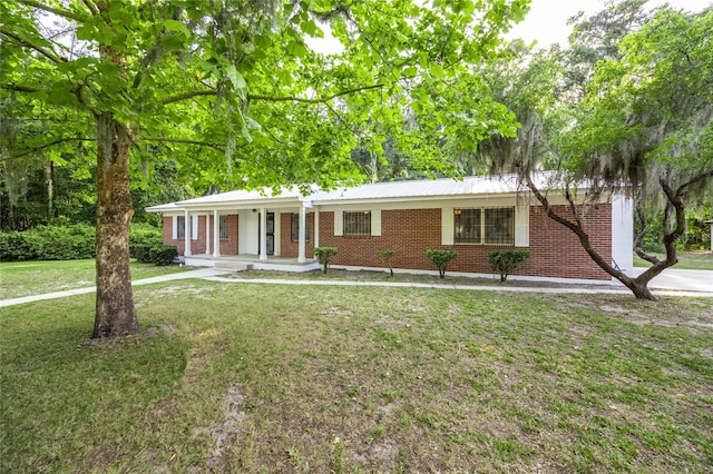 3436 SW 20th St, Gainesville, FL 32608 - single story home featuring a porch, a front lawn, and brick siding