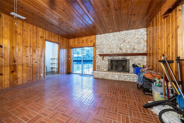 3436 SW 20th St, Gainesville, FL 32608 - unfurnished living room featuring wood walls, a fireplace, brick floor, and wooden ceiling