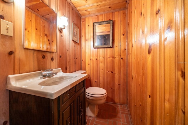 3436 SW 20th St, Gainesville, FL 32608 - bathroom with wood ceiling, wooden walls, toilet, vanity, and brick floor