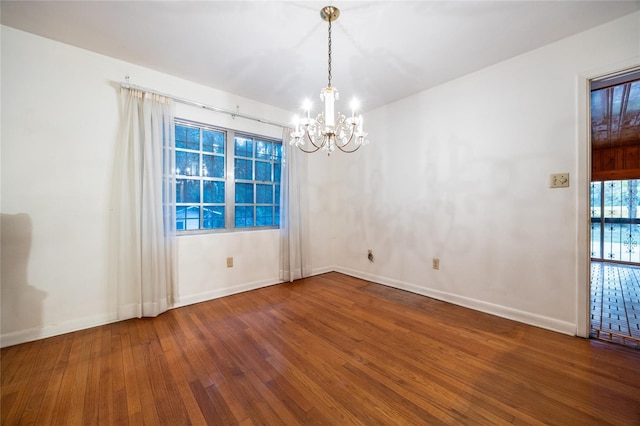 3436 SW 20th St, Gainesville, FL 32608 - unfurnished room with hardwood / wood-style flooring, a chandelier, and baseboards