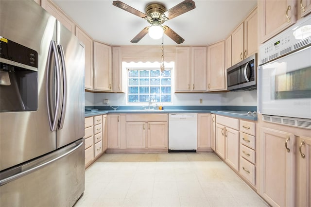 3436 SW 20th St, Gainesville, FL 32608 - kitchen with a sink, ceiling fan, stainless steel appliances, dark countertops, and light brown cabinetry