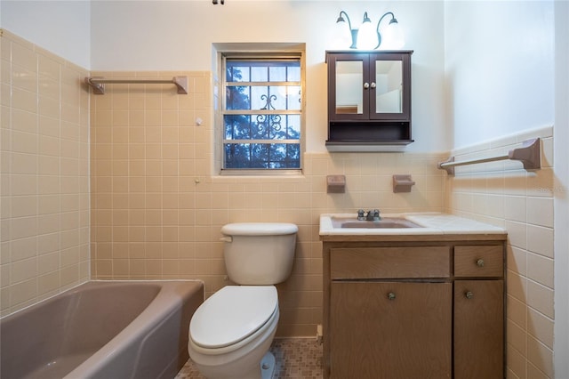 3436 SW 20th St, Gainesville, FL 32608 - bathroom with tile walls, a wainscoted wall, toilet, shower / bathtub combination, and vanity