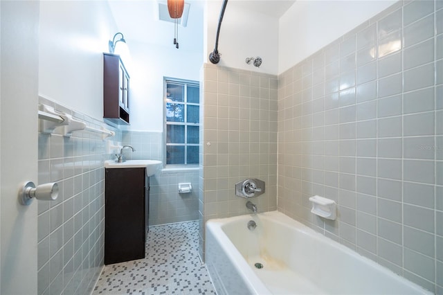 3436 SW 20th St, Gainesville, FL 32608 - full bathroom featuring wainscoting, vanity, tub / shower combination, and tile walls