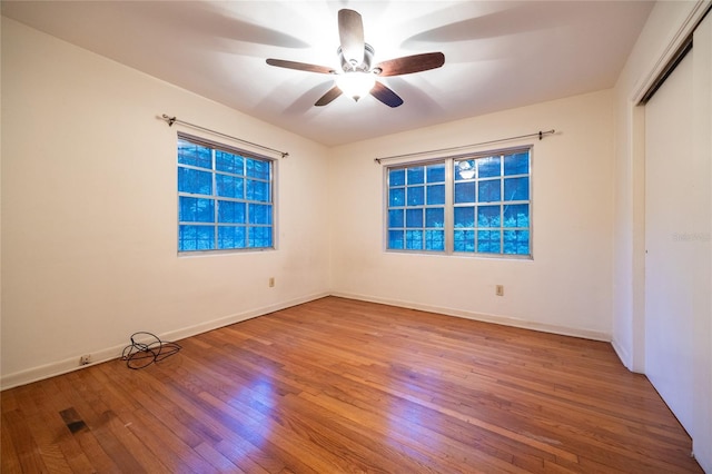 3436 SW 20th St, Gainesville, FL 32608 - unfurnished bedroom featuring a closet, a ceiling fan, wood finished floors, and baseboards