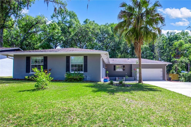 2423 NW 67th Ter, Gainesville, FL 32606 - ranch-style house with an attached garage, concrete driveway, a front lawn, and stucco siding