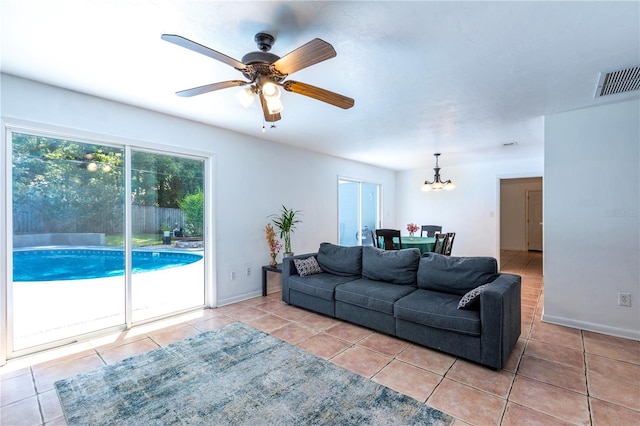 2423 NW 67th Ter, Gainesville, FL 32606 - living area featuring visible vents, tile patterned floors, baseboards, and ceiling fan with notable chandelier
