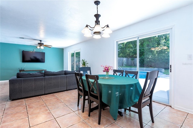 2423 NW 67th Ter, Gainesville, FL 32606 - dining area featuring ceiling fan with notable chandelier, baseboards, light tile patterned floors, and visible vents