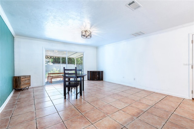 2423 NW 67th Ter, Gainesville, FL 32606 - dining space with light tile patterned flooring, visible vents, baseboards, and ornamental molding