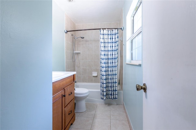 2423 NW 67th Ter, Gainesville, FL 32606 - full bath featuring tile patterned flooring, toilet, vanity, baseboards, and shower / tub combo