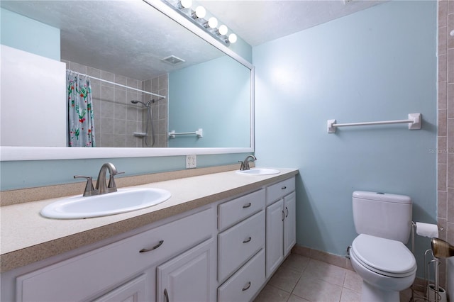2423 NW 67th Ter, Gainesville, FL 32606 - full bath featuring visible vents, tile patterned flooring, toilet, and a sink