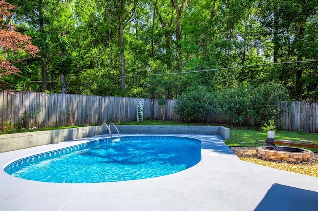 2423 NW 67th Ter, Gainesville, FL 32606 - view of swimming pool featuring a fenced in pool, a patio, a fenced backyard, and an outdoor fire pit