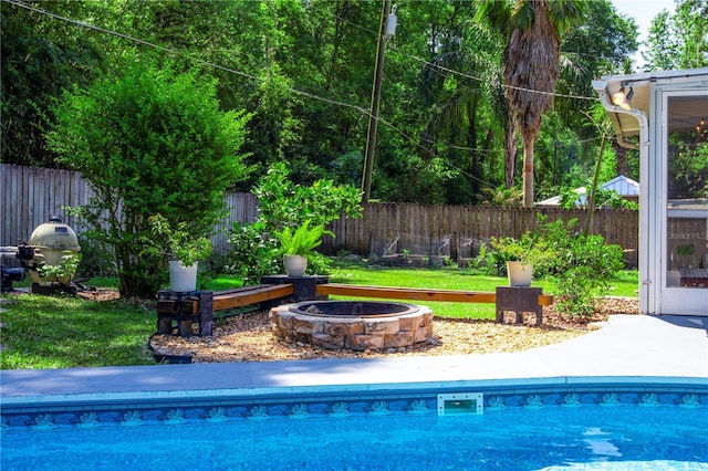 2423 NW 67th Ter, Gainesville, FL 32606 - view of swimming pool with a fire pit, a fenced in pool, a lawn, and a fenced backyard