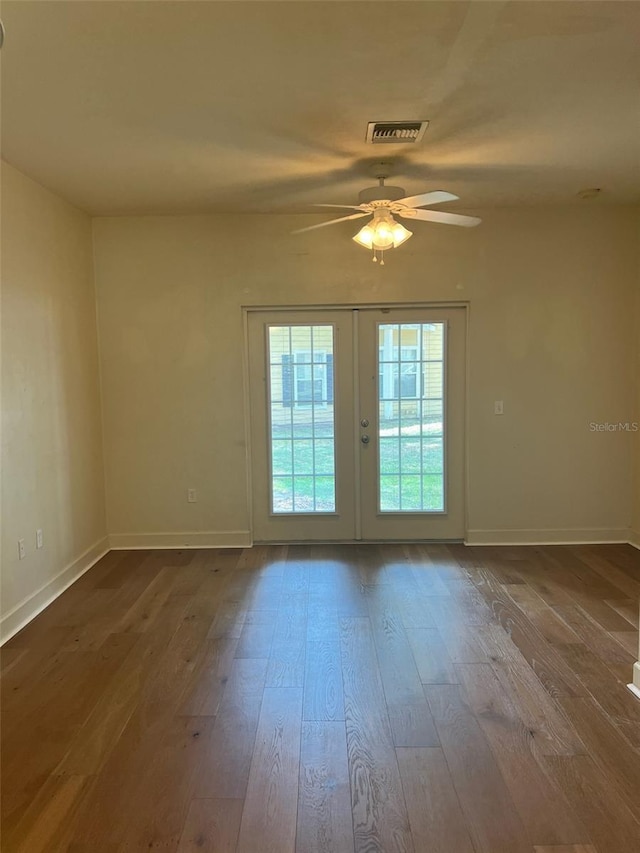 2927 SW 35th Pl Unit 115, Gainesville, FL 32608 - unfurnished room featuring french doors, baseboards, visible vents, wood finished floors, and ceiling fan