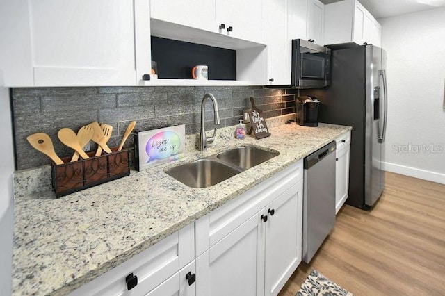418 40th Ave S, Saint Petersburg, FL 33705 - kitchen with appliances with stainless steel finishes, a sink, white cabinets, open shelves, and light wood-type flooring
