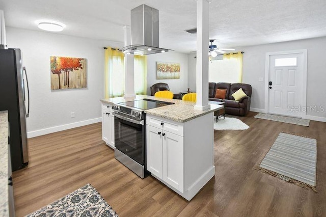418 40th Ave S, Saint Petersburg, FL 33705 - kitchen with appliances with stainless steel finishes, range hood, open floor plan, white cabinets, and baseboards