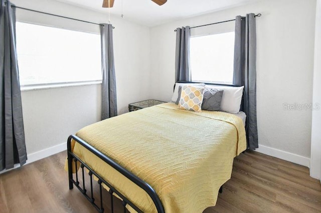418 40th Ave S, Saint Petersburg, FL 33705 - bedroom featuring baseboards, wood finished floors, and a ceiling fan
