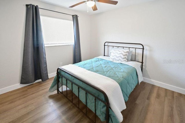 418 40th Ave S, Saint Petersburg, FL 33705 - bedroom featuring baseboards, wood finished floors, and ceiling fan