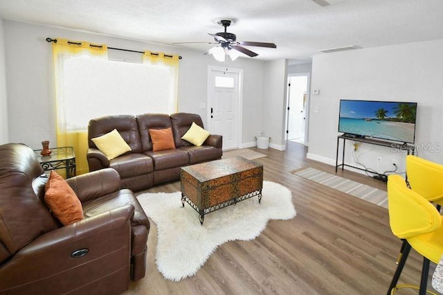 418 40th Ave S, Saint Petersburg, FL 33705 - living room featuring wood finished floors, a ceiling fan, and baseboards