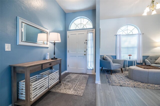 6114 NW 35th St, Gainesville, FL 32653 - entrance foyer featuring a chandelier, baseboards, and wood finished floors
