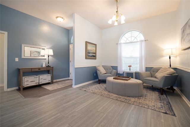 6114 NW 35th St, Gainesville, FL 32653 - sitting room featuring a notable chandelier, wood finished floors, and baseboards
