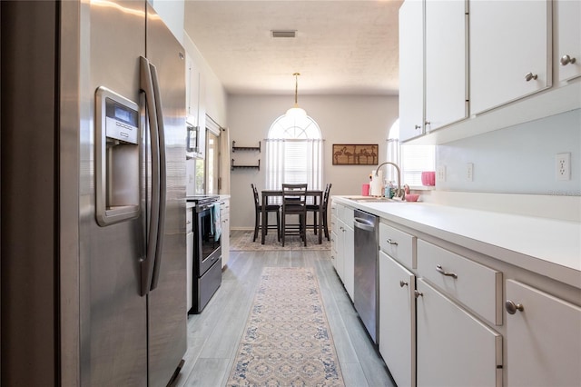 6114 NW 35th St, Gainesville, FL 32653 - kitchen featuring a sink, stainless steel appliances, visible vents, light countertops, and white cabinets