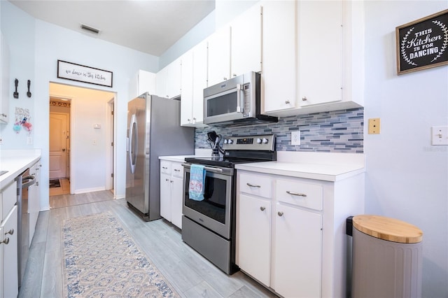 6114 NW 35th St, Gainesville, FL 32653 - kitchen with appliances with stainless steel finishes, light countertops, backsplash, light wood-type flooring, and visible vents