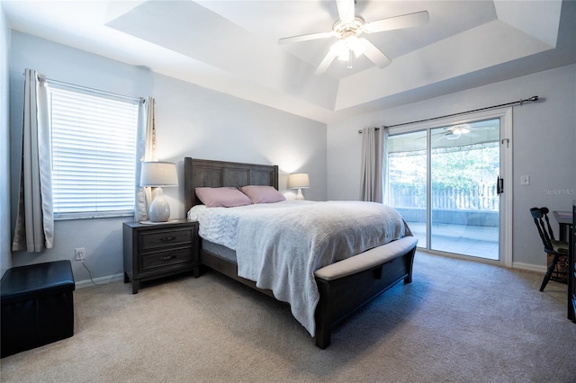 6114 NW 35th St, Gainesville, FL 32653 - bedroom with access to outside, light carpet, ceiling fan, baseboards, and a tray ceiling